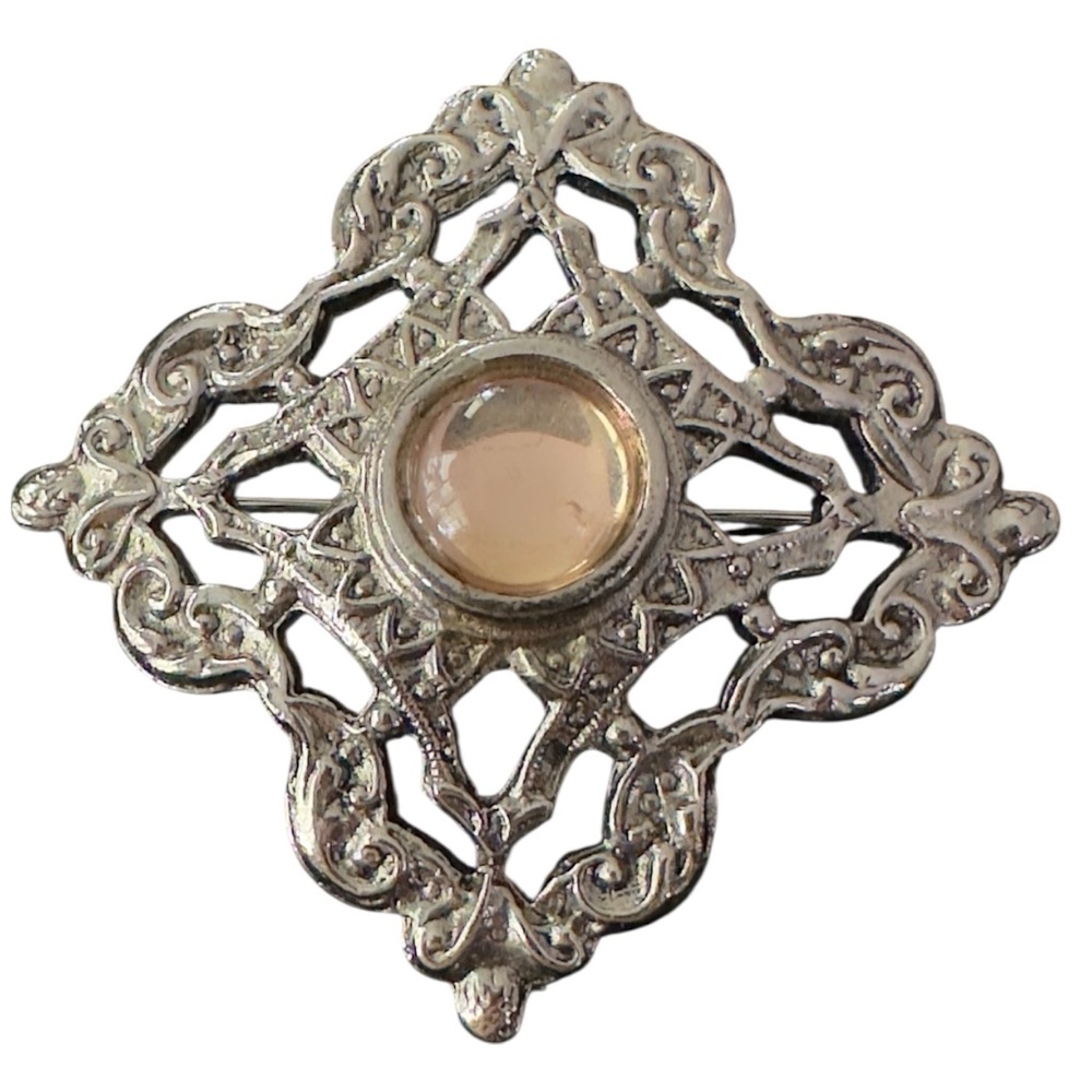 Ornate Silver Brooch with Center Stone
